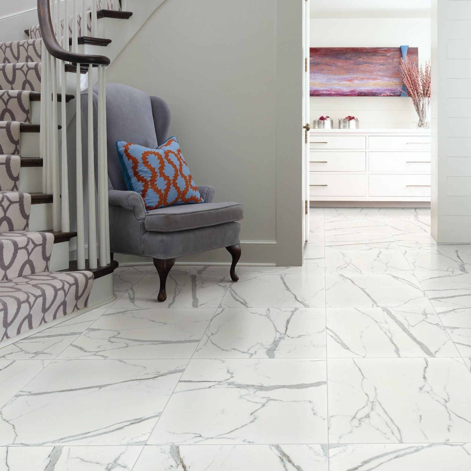 Foyer with stair case and chair on tile - Lacey's The Carpetmaster in VT