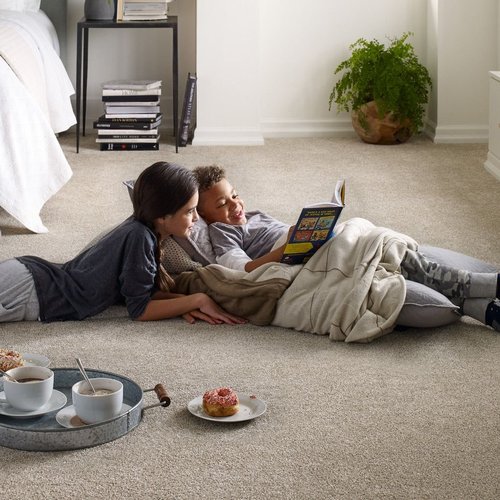 Two people reading on the ground with carpet - Lacey's The Carpetmaster in VT